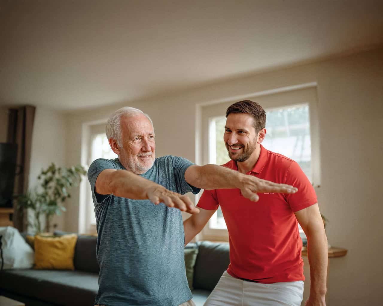 Caregiver helps client with light exercise in hospital to home care service