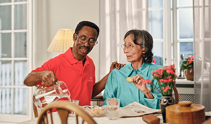 Carer pours tea for Dovida client