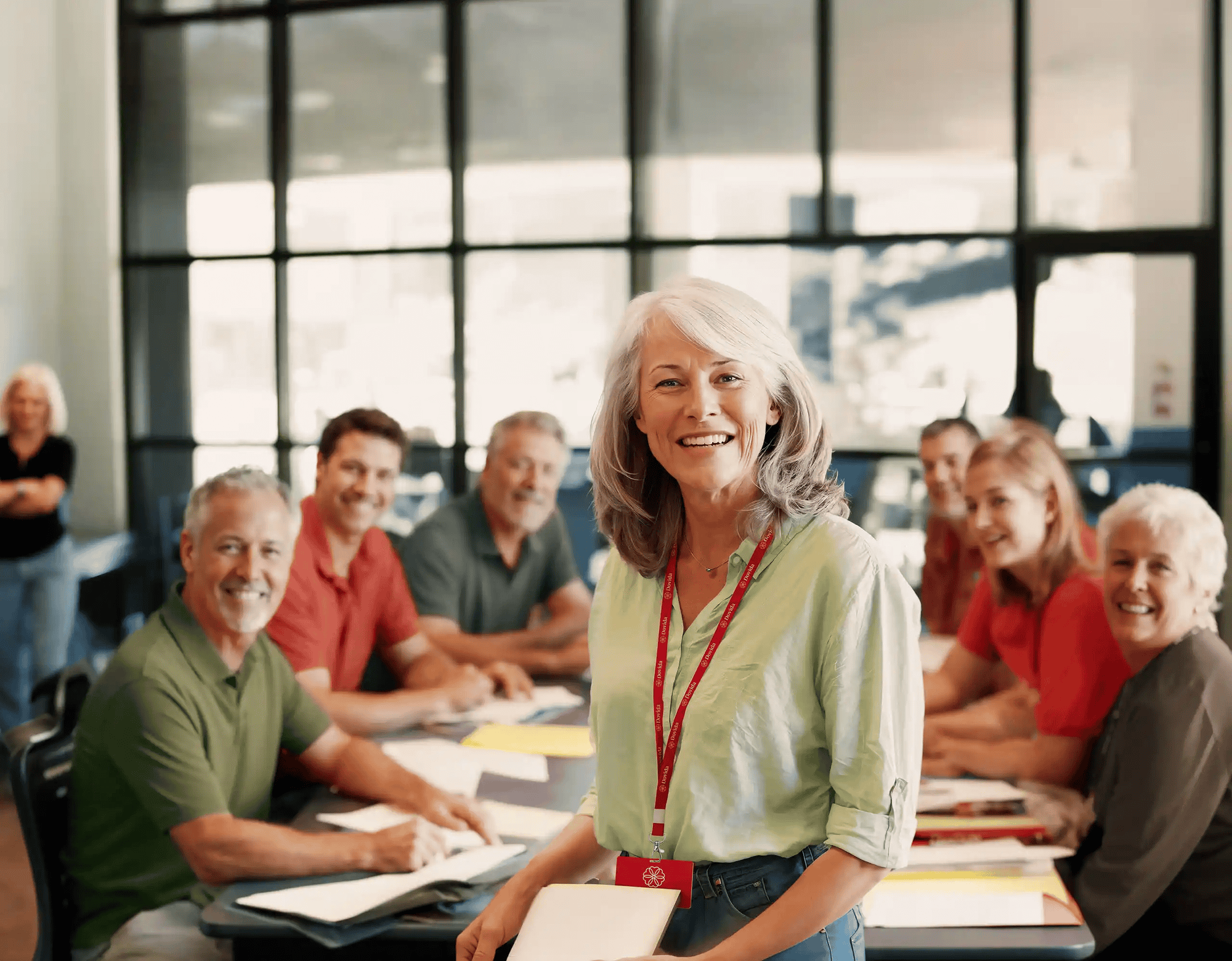 Dovida Caregivers at a training session, with the smiling tutor front of picture